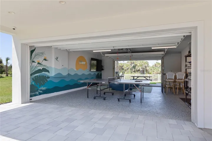 From ping pong to sunsets, this vibrant pass-through garage hangout blends play and relaxation in true coastal style.