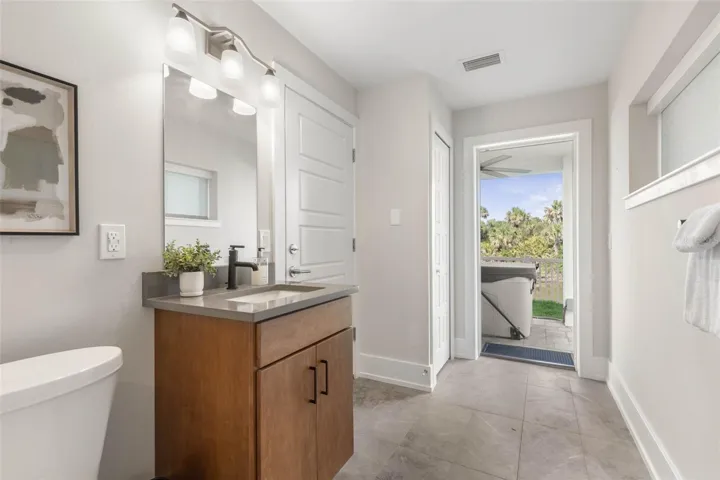 This convenient full bath offers direct access to the backyard and hot tub—perfect for rinsing off after a soak or transitioning seamlessly from outdoor fun to indoor comfort.