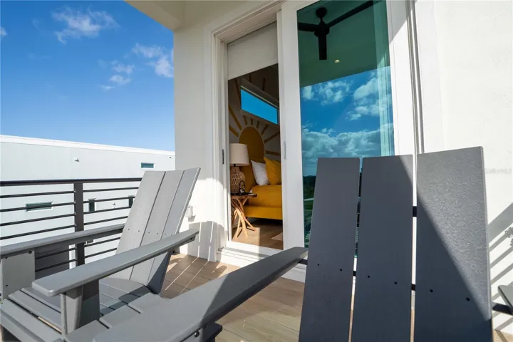 Wake up and unwind with private balcony access from this cheerful, sun-kissed bedroom.