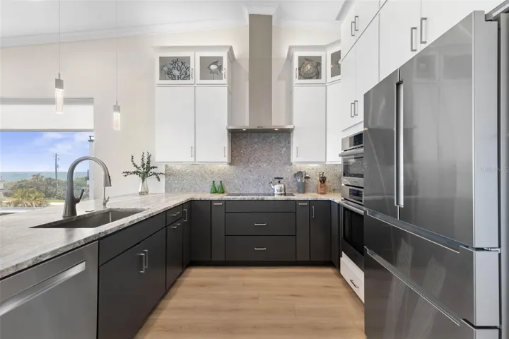 Where luxury meets livability—this designer kitchen features a convection oven and space to bring the whole family together.