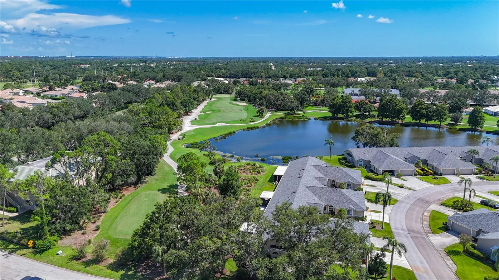 Aerial view of 8th fairway, with the natural green space between the golf course and the rear of the villas.