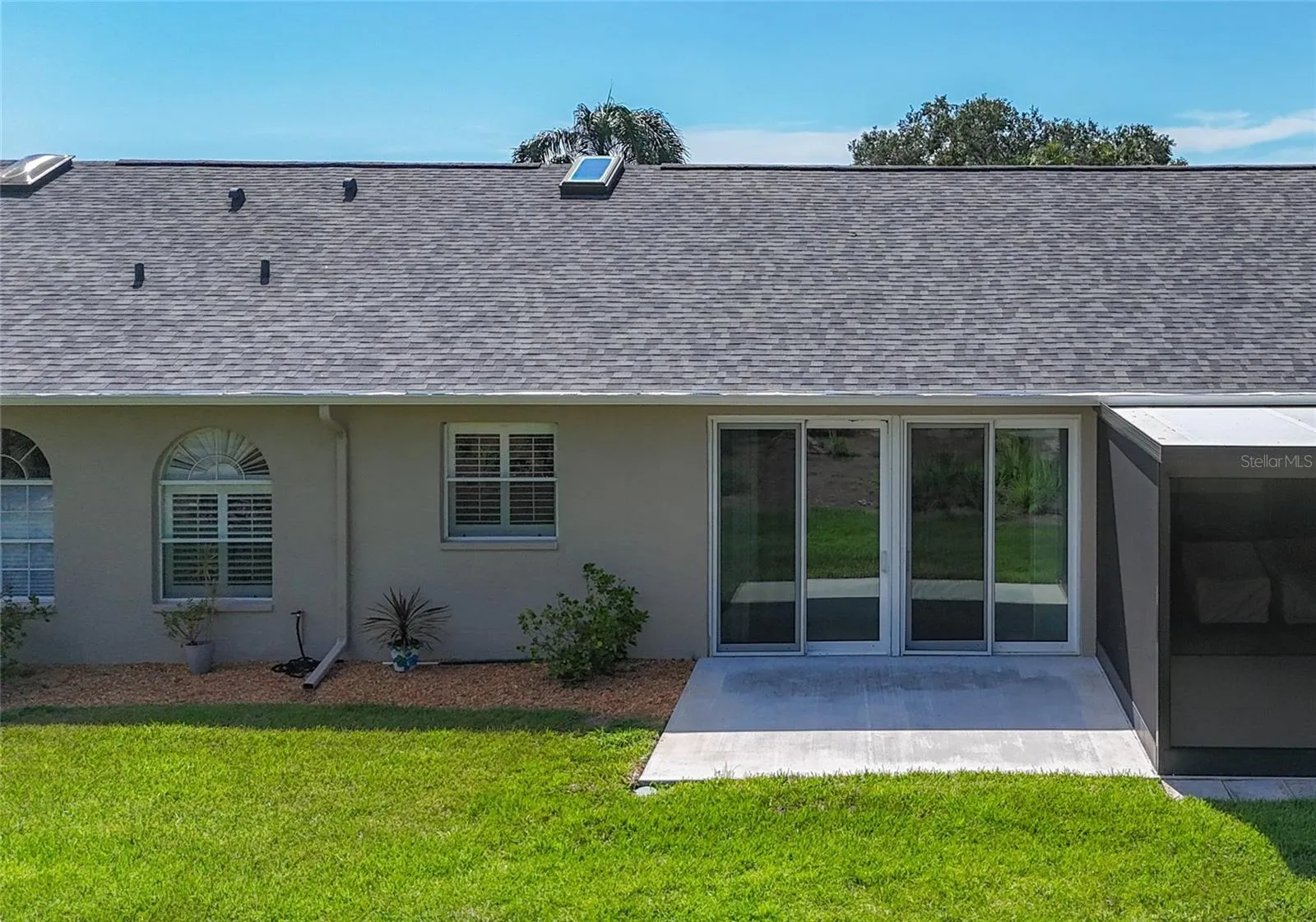 Back of villa includes large concrete patio to enjoy the beautiful view of the 8th tee of the golf course