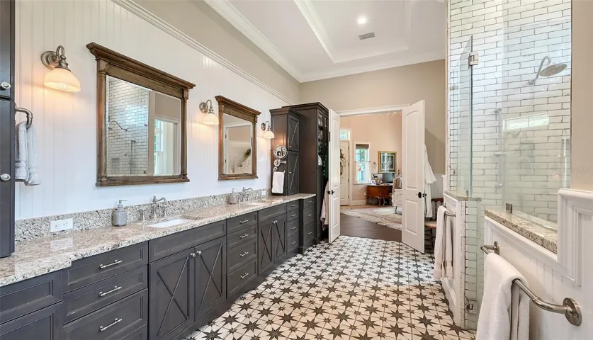 Prepare to be dazzled by the Primary Bathroom, an expansive 19' x 13' oasis that redefines luxury! This stunning space features a breathtaking freestanding Mirabelle tub complete with a sleek Moen chrome filler and faucets, perfect for soaking in style.