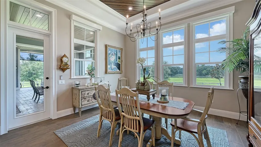 The Dining Room features custom treatments that include painted poplar beams and #2 cypress tongue-and-groove (V-joint, pre-finished Synergy wood), creating a warm and inviting atmosphere. The space is further enhanced by elegant 7 1/4" or 5 1/2" crown molding, adding a touch of sophistication to your dining experience.