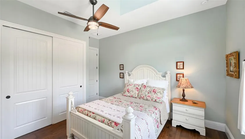 Upstairs, Bedroom #4 measures 13' x 12' and offers a charming view of the long, winding oak-lined driveway, creating a picturesque backdrop that enhances the room's inviting atmosphere.