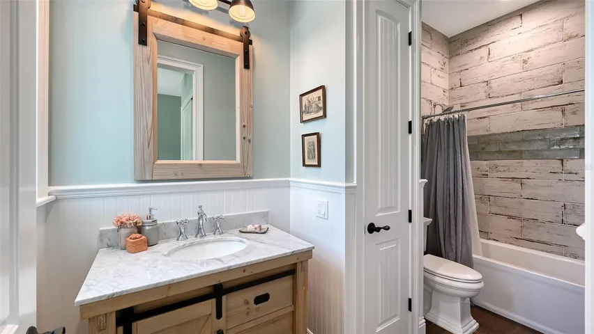 Upstairs Bathroom #4 measures 5' x 13' and features a charming freestanding vanity that adds a touch of elegance to the space. The bathroom is designed for both style and functionality, showcasing a convenient combination tub and shower that invites relaxation. This delightful bathroom offers a perfect blend of comfort and practicality, making it an inviting retreat for guests or family members.