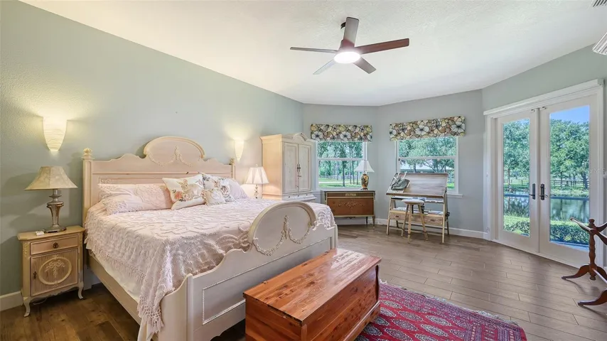 The owner's suite is a true sanctuary, featuring large bay windows with thermopane glass that offer stunning views of the back lake, along with a charming French door that opens to the spacious lanai. This serene space overlooks a picturesque pond, beautifully framed by mature oak trees draped in Spanish moss, creating a tranquil and inviting atmosphere.The suite also boasts two generous walk-in closets, enhancing the overall functionality of the space. With the added benefit of thermopane doors and windows, you can enjoy energy efficiency and comfort while basking in the natural beauty of your surroundings. This combination of modern features and natural elegance makes the owner's suite a perfect retreat for relaxation and rejuvenation.