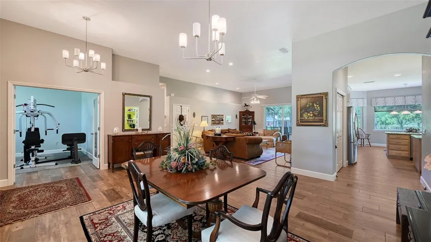 This stunning residence features three perfect bedrooms and two highly upgraded bathrooms, providing ample space for comfort and relaxation. Entertain in style with a formal dining room, a spacious Great Room, and a HUGE breakfast nook that invites gatherings. The large laundry room and three-car garage with tandem parking add convenience to your daily routine.At the heart of the home lies a simply fantastic kitchen, designed for the chef who truly loves to cook, making meal preparation a joy. Step outside to the expansive screened-in lanai, where watching breathtaking sunsets over the back lake becomes an absolute must.As you approach the home, the concrete driveway is lined with majestic oak trees, creating a picturesque entrance that beautifully frames the property. The south pasture is also heavily adorned with oaks, enhancing the serene and natural beauty of this exceptional estate. This home is not just a place to live; it’s a lifestyle waiting to be embraced!