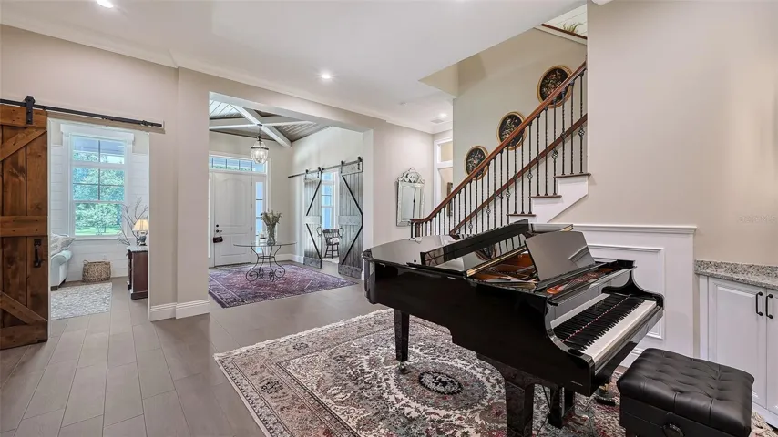 This spacious living room is generously sized to accommodate even a grand piano, creating an elegant focal point for gatherings and entertaining.