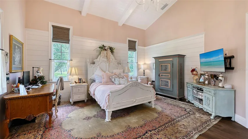 Step into Primary Bedroom #2, a spacious 20' x 18' retreat that exudes luxury and style! This stunning room features soaring vaulted ceilings adorned with custom treatments, including beautifully painted poplar beams and exquisite #2 cypress tongue-and-groove (V-joint, pre-finished Synergy wood). Completing this dream space is a remarkable custom closet measuring 15' x 14', offering ample storage and organization while maintaining the room's chic aesthetic. This is not just a bedroom; it’s a personal sanctuary designed for ultimate comfort and elegance!