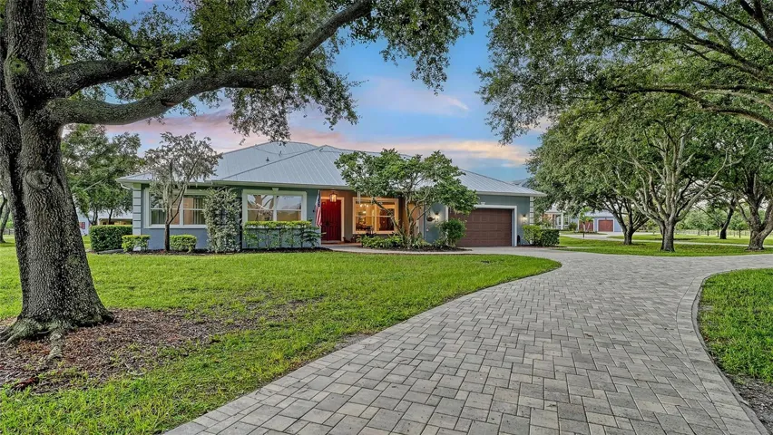 The Guest Home: Discover this beautifully remodeled 3-bedroom, 2-bath guest house, expertly crafted with durable concrete block construction and topped with a modern 2025 metal roof. Nestled among mature oak trees, this charming retreat overlooks a scenic reflection pond and the picturesque barn, creating a serene and inviting atmosphere. Every detail has been thoughtfully designed to provide comfort and style, making this guest house a perfect sanctuary for visitors or a delightful space for family gatherings. Enjoy the tranquility of nature while being just steps away from the main residence! Experience unparalleled protection with full Kevlar hurricane screens and double-paned thermopane windows and doors throughout the entire home! These exceptional features ensure your peace of mind while enhancing energy efficiency and comfort year-round.