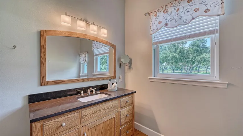 A beautifully hand-crafted sink with a stunning quartz countertop completes this Spa Bathroom, and a 80-gallon hot water heater ensures that you’ll never run out of hot water, allowing for long, indulgent baths and showers. Additionally, a solar attic fan enhances the home’s energy efficiency, making this bathroom not only a place of comfort but also a model of modern sustainability. This spa-like oasis is designed to elevate your daily routine into a truly rejuvenating experience!
