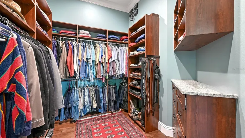 Primary Suite #1 features a custom closet that will truly delight, boasting hard shelving designed for ultimate organization and style! Measuring an impressive 12' x 8', this spacious closet is a dream come true for anyone seeking both functionality and elegance.