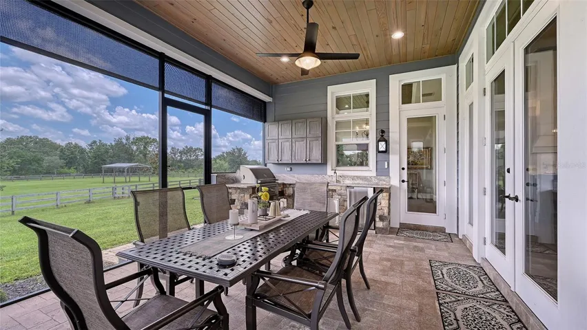 The 1,000 sq ft entertainment area is a true marvel, designed to provide both luxury and peace of mind. Featuring superior hurricane protection, this space is equipped with Super Screens and two robust 3080 welded-frame screen doors, ensuring that you can enjoy the outdoors without worry, no matter the weather.Enhancing the comfort and functionality of this area are the roll-down solar screens, specifically the Shade & Shields Zip Tex Pro with Twitchell Nano 9.5 fabric in sleek black, offering 5% openness for optimal light control and privacy. These innovative screens are fitted with smart motors, allowing you to effortlessly adjust them with the touch of a button, creating the perfect ambiance for any occasion.Whether you’re hosting a lively gathering or enjoying a quiet evening under the stars, this entertainment area combines cutting-edge technology with thoughtful design, making it an ideal space for relaxation & enjoyment. Experience the ultimate in outdoor living, where comfort meets sophisticat