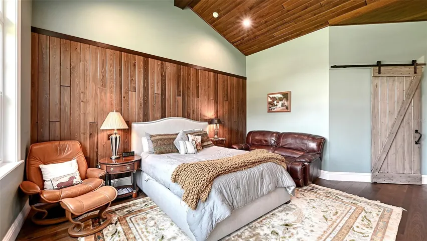 The Dual Primary Suites are adorned with the exquisite Naturally Aged Medallion Collection wire-brushed oak flooring in a rich Maui Brown, measuring 5/8" thick. This elegant flooring extends gracefully into the hallways and walk-in closets, creating a warm and inviting atmosphere throughout.