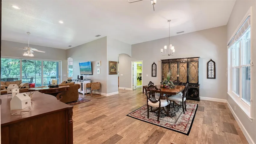 The floor plan is open and airy, featuring a seamless combination of the dining and Great Room that effortlessly flows into the lanai, showcasing those breathtaking park views. The family room, measuring 17' x 20', boasts impressive 11' ceilings, creating a spacious and inviting atmosphere perfect for both relaxation and entertaining. This thoughtfully designed layout enhances the sense of light and space, making it an ideal setting for gatherings with family and friends while enjoying the beauty of the outdoors.