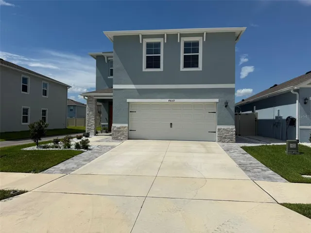 Front of the house with extended driveway.