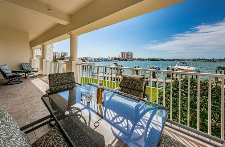 .. 45 Foot Water Front Balcony.. Looking From Outside Living Room Towards NW. - This Large Body of Water is called Boca Ciega Bay or Sometimes the Intracoastal Waterway.. It Feeds into the ' Gulf of America  "about 5 miles South of us at Johns Pass - Or 7 Miles North of us at the Clearwater Pass. Note: Balcony with Furniture.