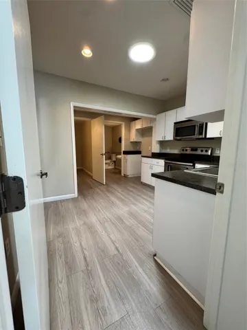 Kitchen with view to Bathrooms