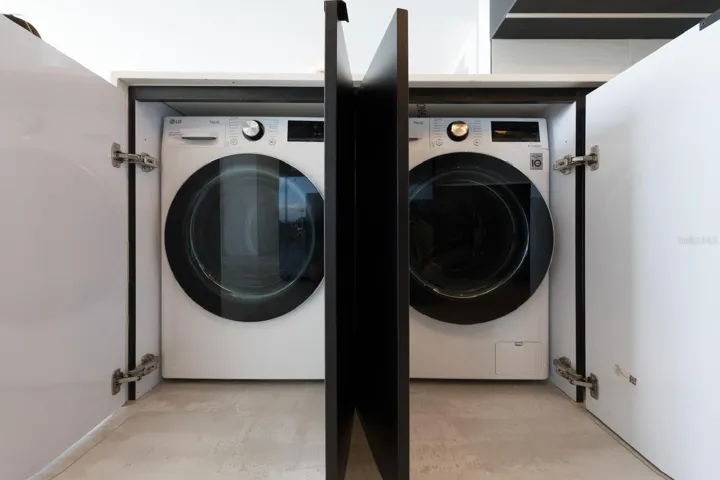 Laundry hidden in kitchen cabinets