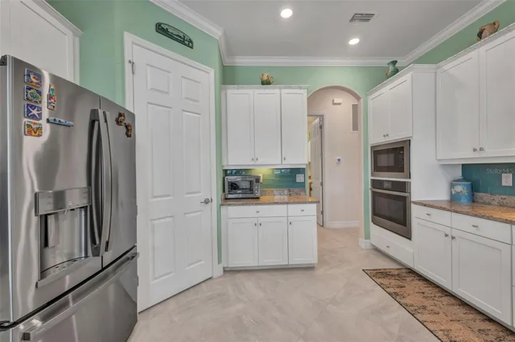 Stainless French Door Refrigerator/Freezer. Hallway out to laundry room and garage.