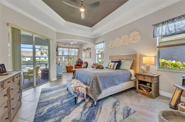 Cozy Primary Bedroom with sliding glass doors to pool and a sitting room.