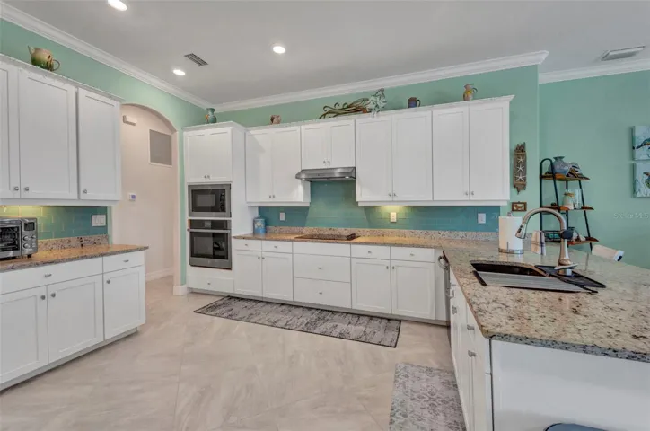 Plenty of granite countertops, canned lights in ceiling.