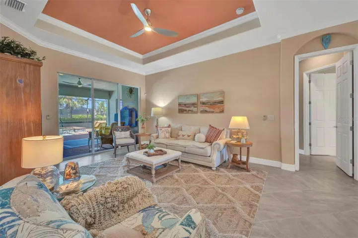 Formal living room with crown molding around the room and within the tray ceiling.