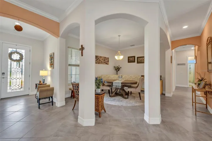 Forming dining room set off by stately pillars.