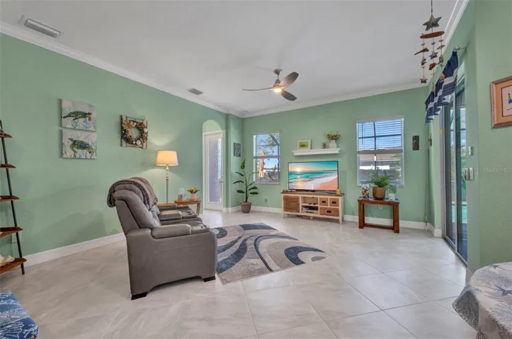 Family room has crown molding and lighted fan.