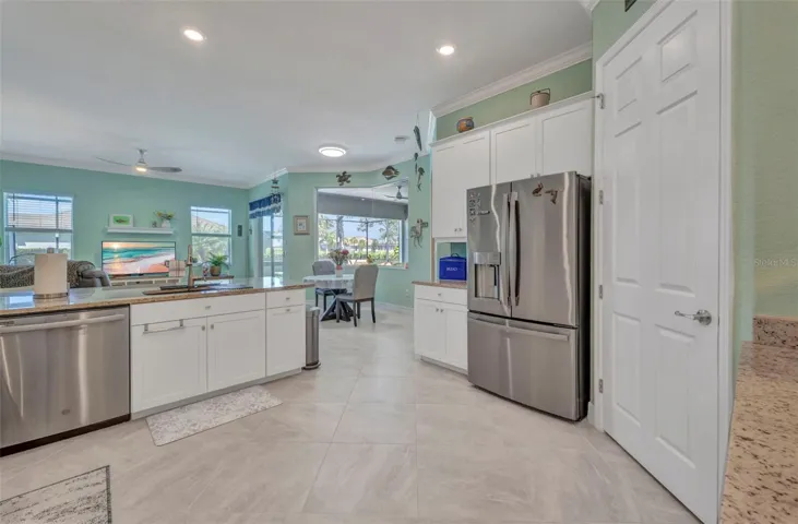 Pantry on the right, upgraded refrigerator and breakfast nook in center with aquarium window.