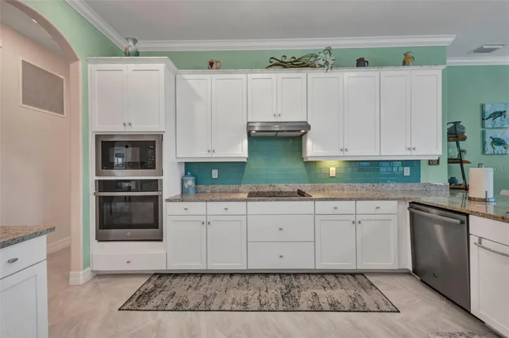 Built-in convection oven and microwave. Lots of cabinets with crown molding on walls and cabinets.