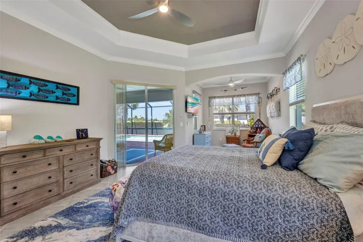 Nice tray ceiling with lighted fan, crown molding and lots of windows for light.