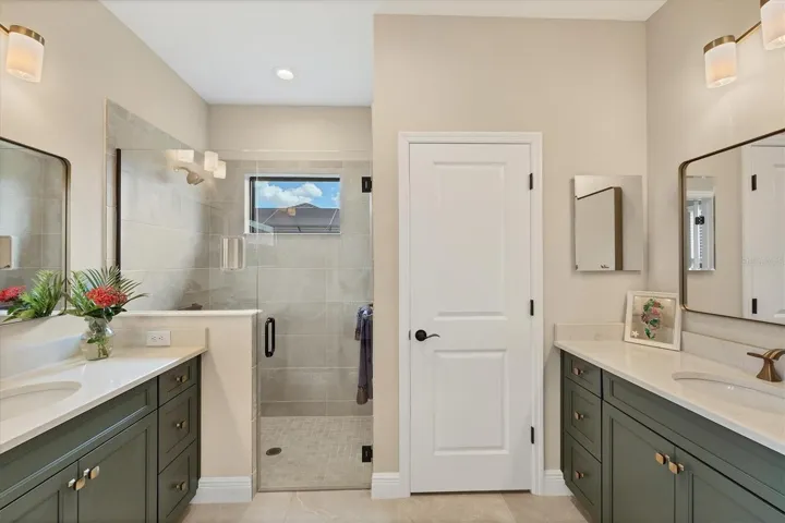 The ensuite primary bath offers split dual vanities, a spacious walk-in shower, and a water closet.