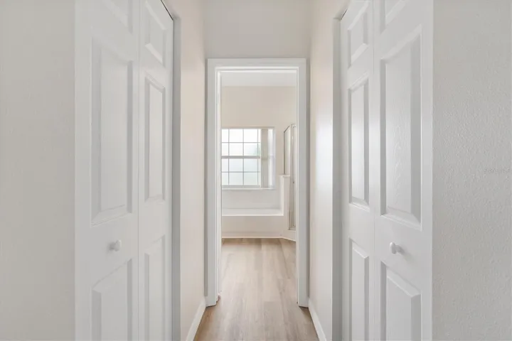 Hall way to Primary bath with his and her closets.  New LVP flooring.  Freshly painted interior.