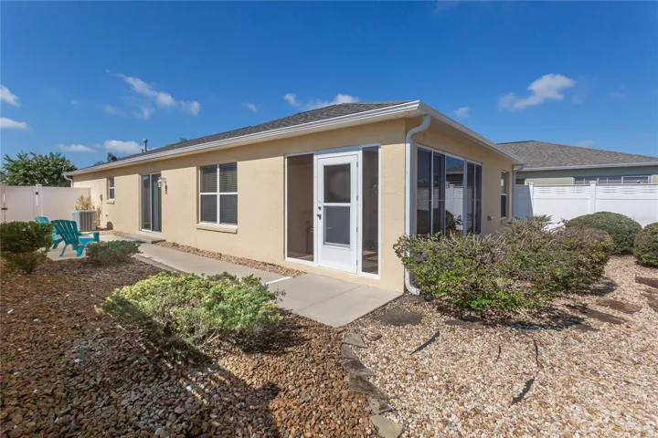 Back of home with entrance to enclosed lanai