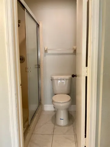 17-Primary bathroom with door to step-in shower and commode