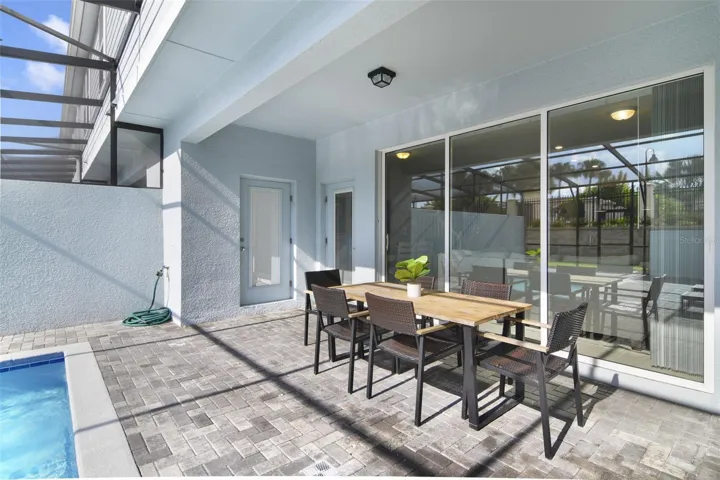 Enjoy the best of both worlds with a covered patio for outdoor dining, just steps from the inviting pool.