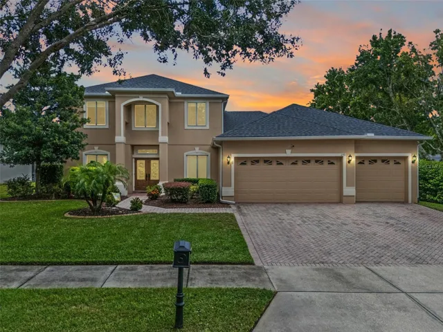Front Exterior Well-Maintained Lawn and Pavered Driveway and Walk