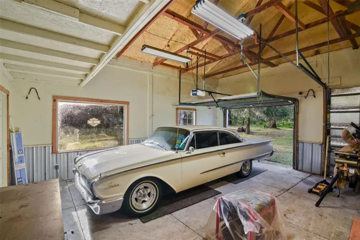 Garage #2 with car lift and 1 car bay on one side with 2 car garage and half bathroom on the other side (35ft x 48ft)