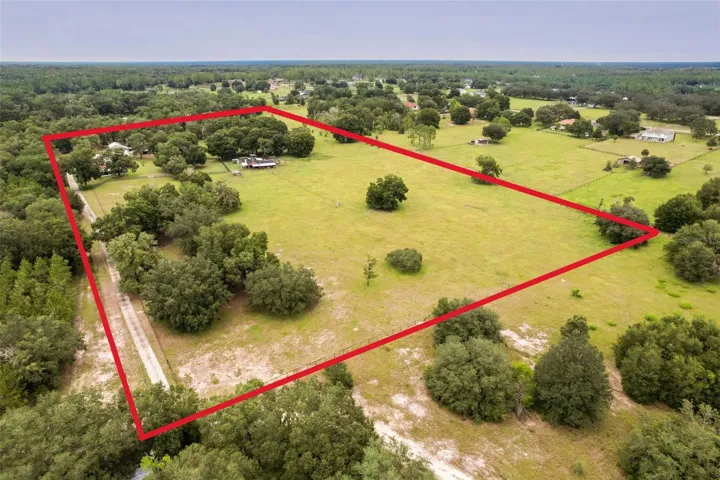 Aerial view highlighting approximately 20 acres of land and overall property layout
