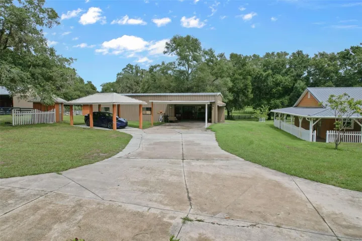 Garage #1 red-iron, concrete floor, office, full bathroom with shower, plumbing and electricity.(28.5ft x 56.5ft) Wrap around porch and back of main home to the right.