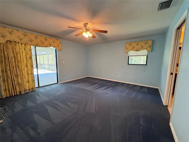 Primary Bedroom, large with sliders to the pool area.