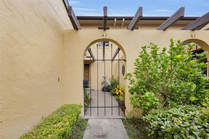 Private gated front entrance with a peaceful courtyard