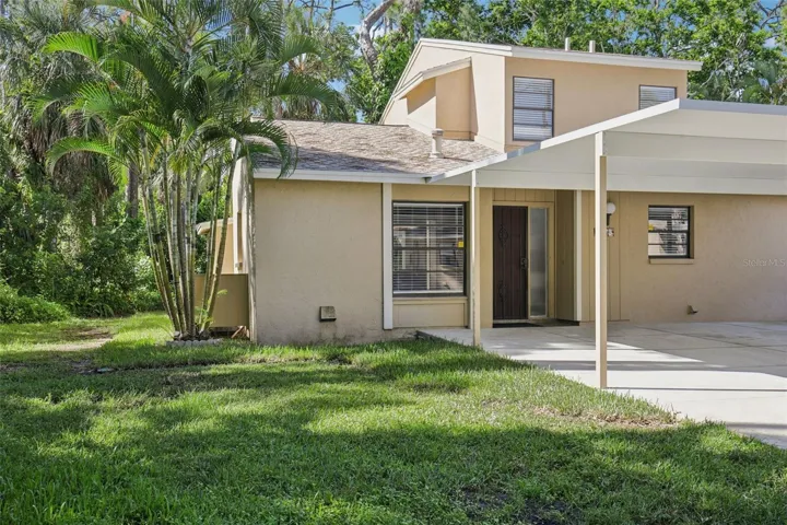 Front of home with double covered carport.