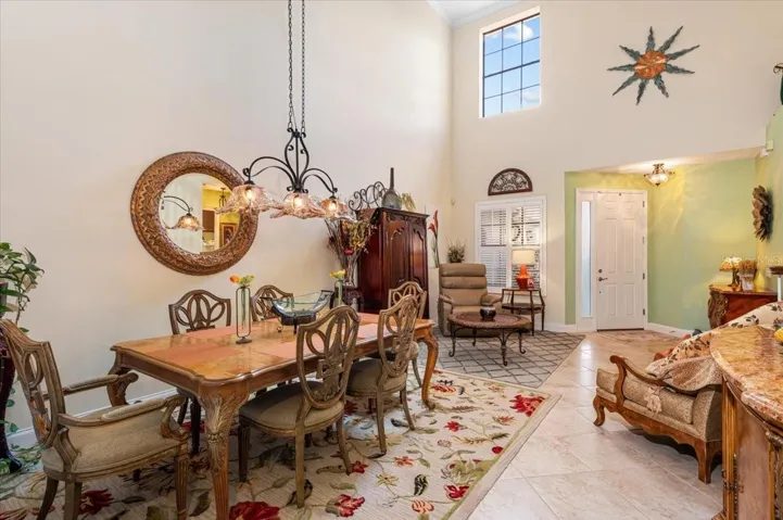 Formal dining area with high ceilings and lots of natural light.