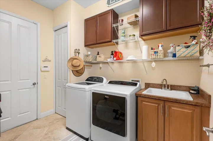 Laundry room with access to the garage.  Storage closet and wash sink