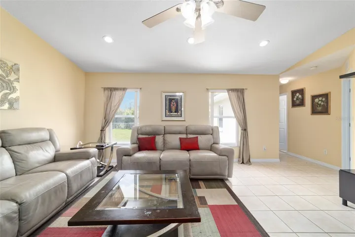 Living room with sliders, double windows and modern lighting