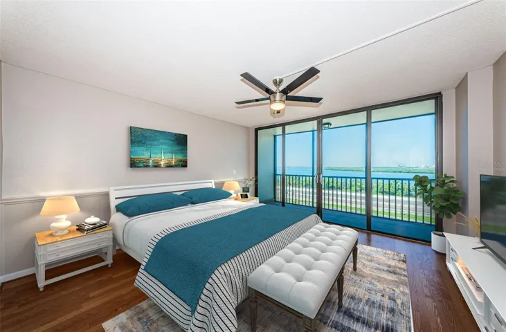 Virtually staged primary bedroom with balcony and floor to ceiling sliders