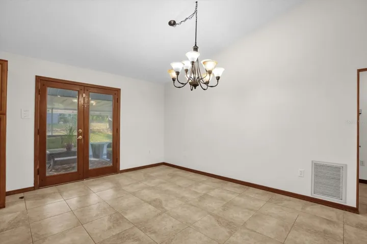 Dining room area with French doors leading to outdoor screened living room